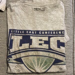 Gray and blue college track and field conference t-shirt.